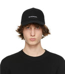 Man wearing black Givenchy logo designer baseball cap